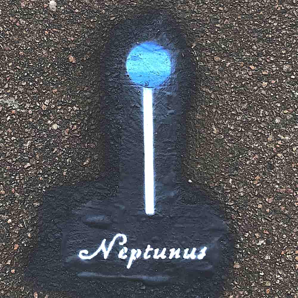 Planet Neptune, 4.9 cm in diameter, painted on the pavement with the Latin name tag Neptunus.